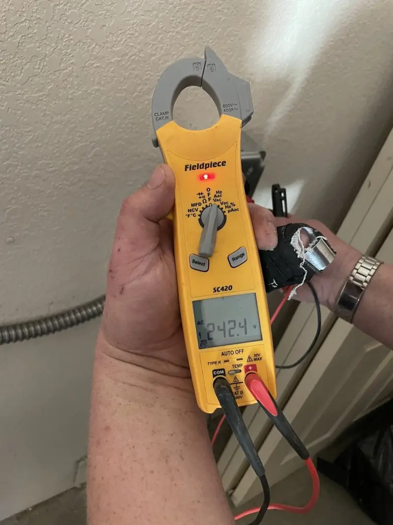 Voltage testing with clamp meter during Outlet Installation in Magna